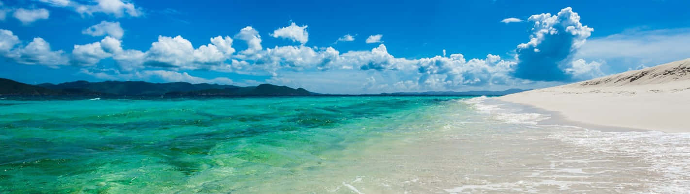 Clear Blue Seashore As A Panoramic Desktop Wallpaper