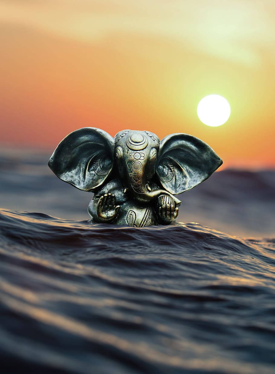 Ganesha Figurine On Ocean Sunset Wallpaper