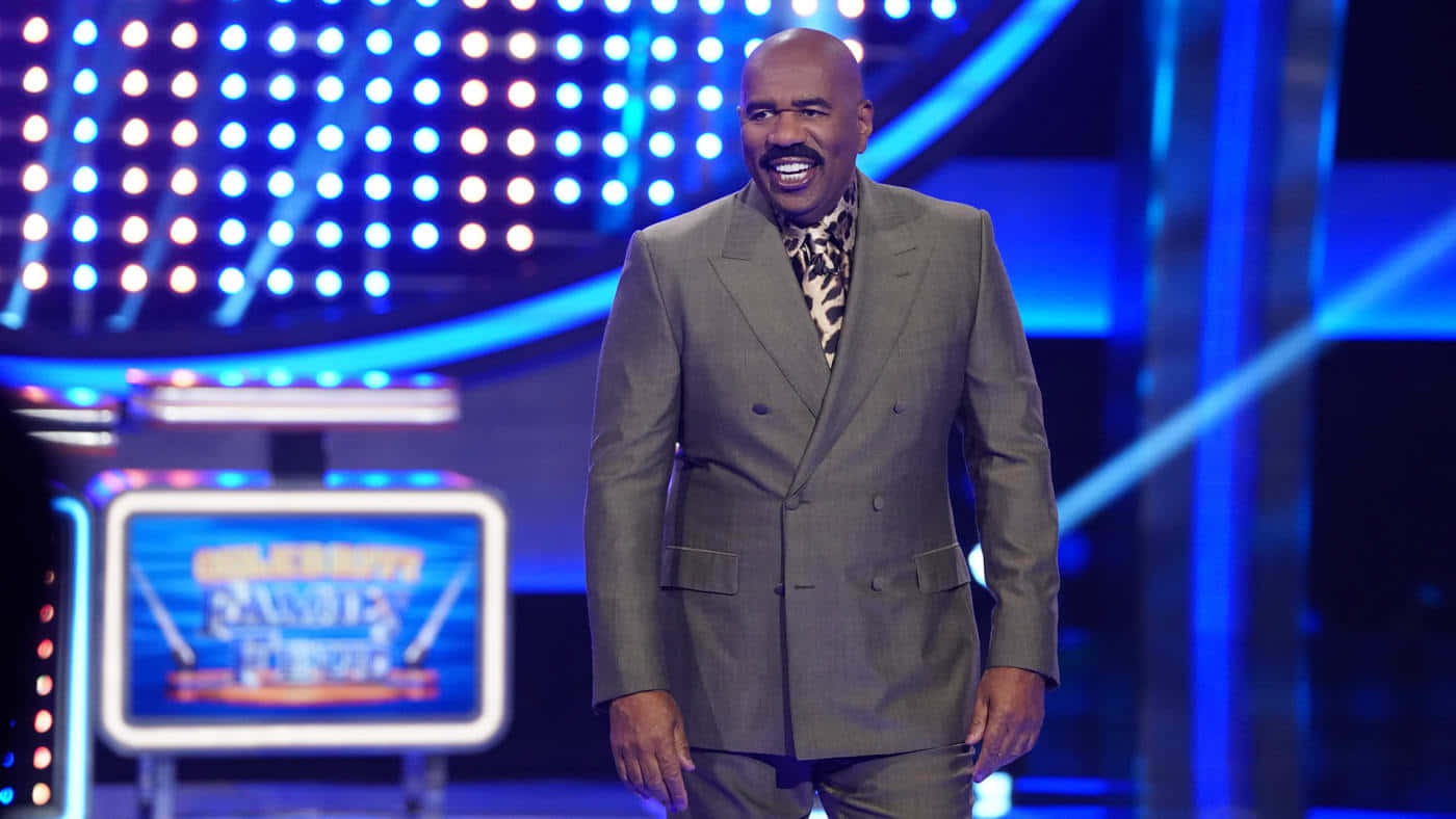 Steve Harvey With Blue Game Show Backdrop Wallpaper