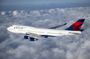 Delta Airlines Plane On Sea Of Gray Clouds Wallpaper