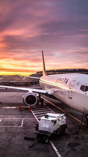 Delta Airlines Truck And Plane At Sunset Wallpaper
