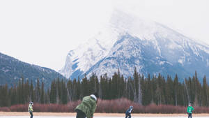 Hockey Players On Banff National Park Wallpaper