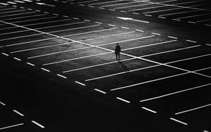 Person Alone In A Parking Lot Wallpaper