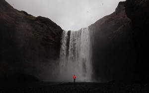 Person Alone Near Waterfall Wallpaper