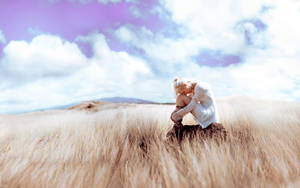 Sad Girl Alone In Grass Field Wallpaper