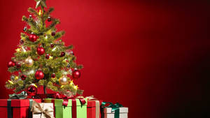 Small Christmas Tree With Gifts Wallpaper