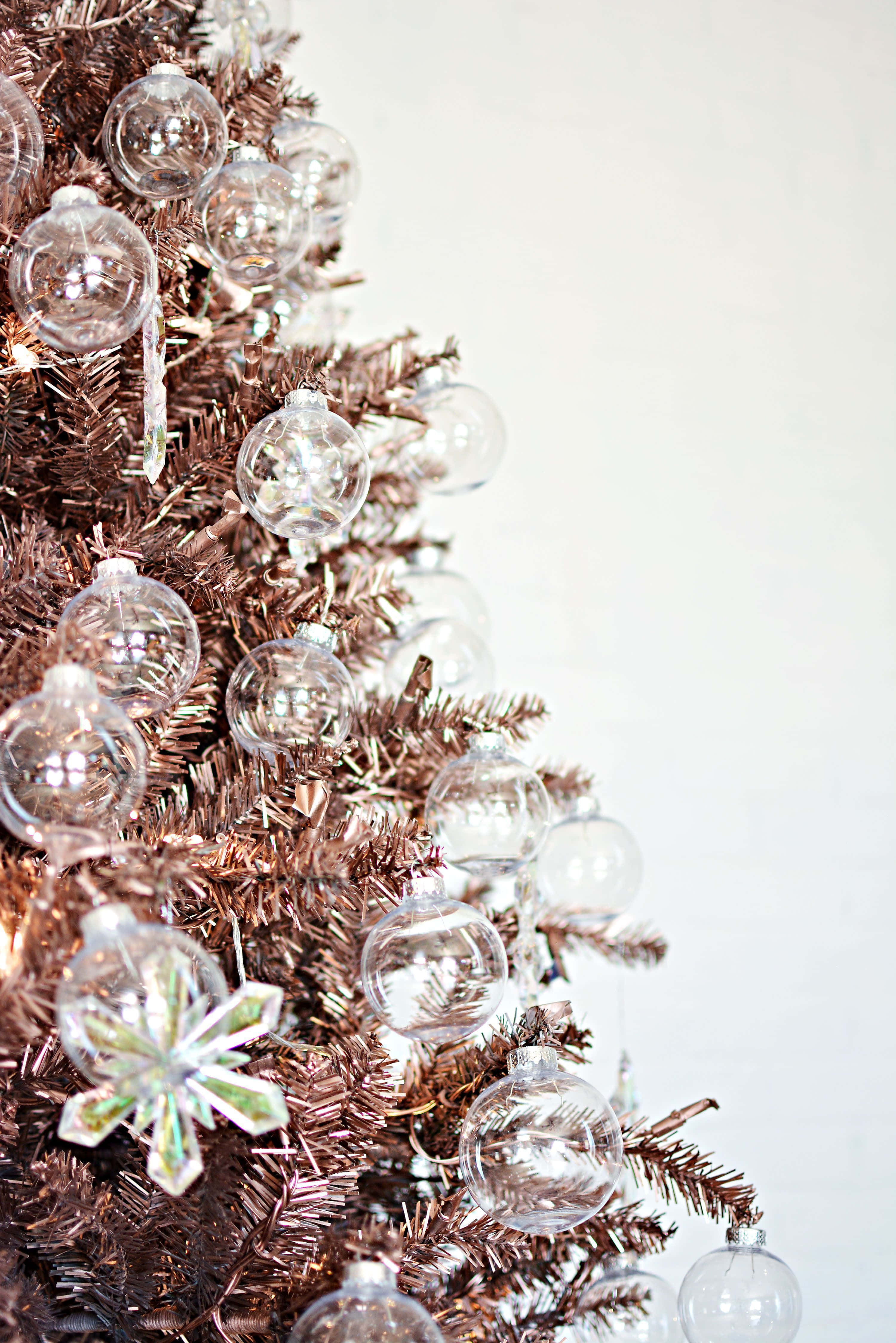 A Beautiful, Snow-covered Aesthetic Christmas Tree Standing Tall In A Winter Landscape