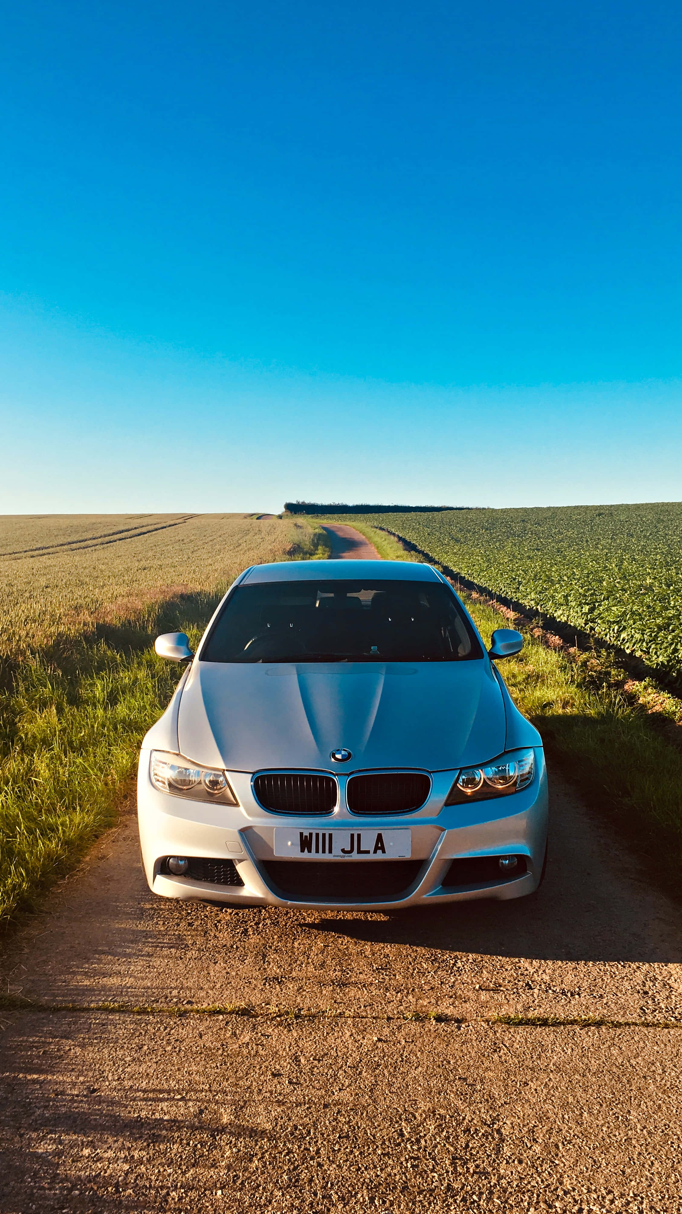 A Car Parked On A Dirt Road
