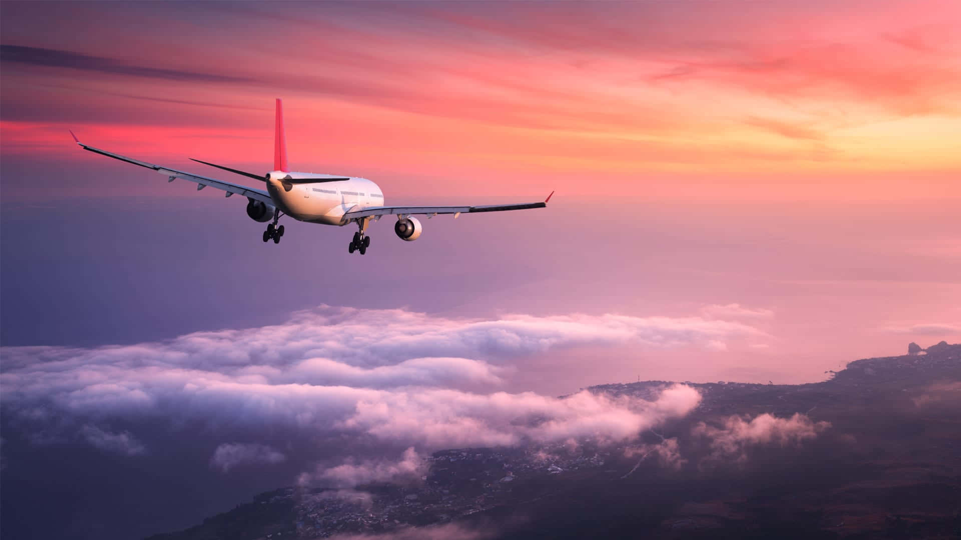 A Pink Passenger Plane Flying In The Sky Against A Backdrop Of Clouds