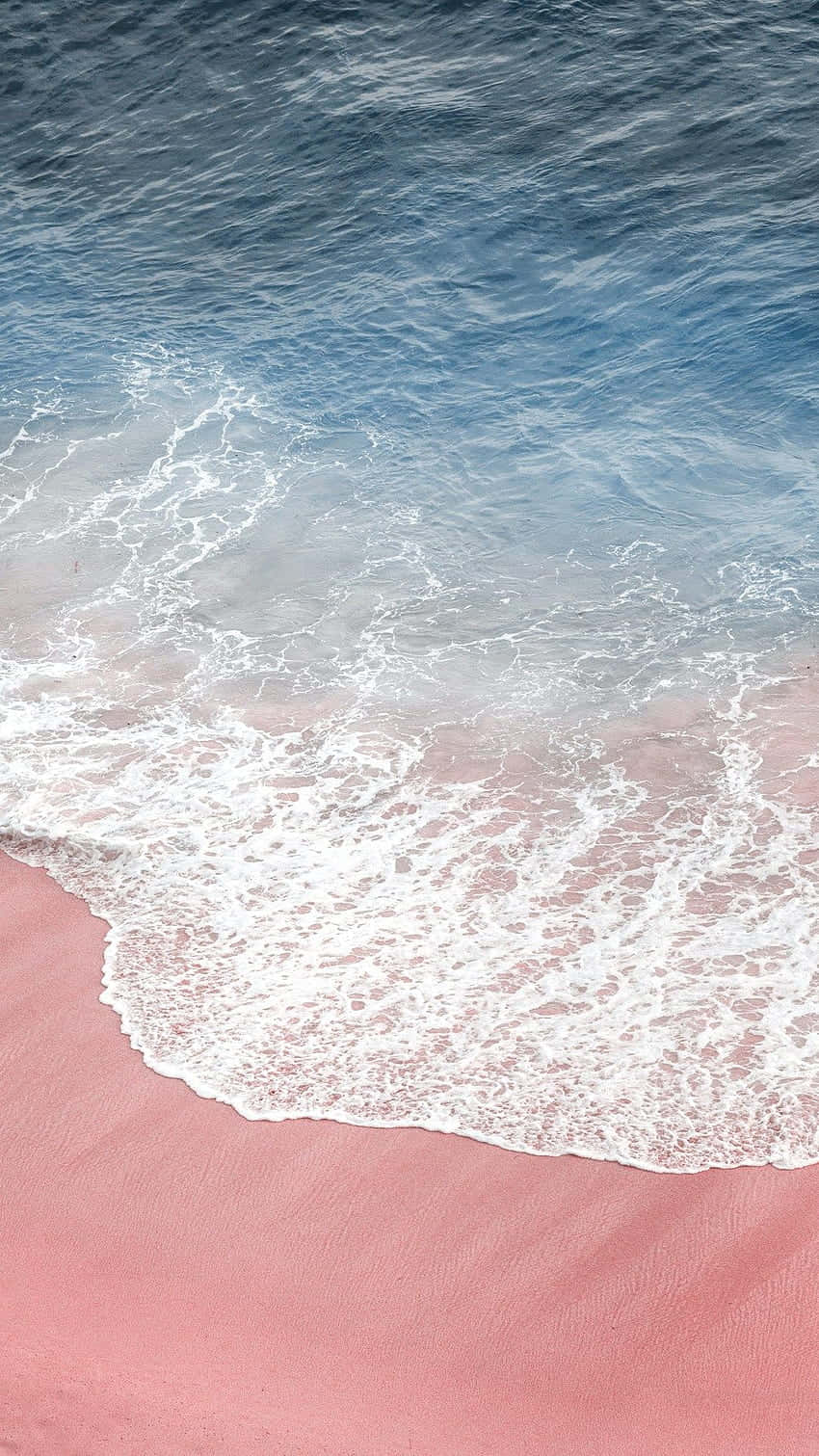 A Pink Sand Beach With Waves