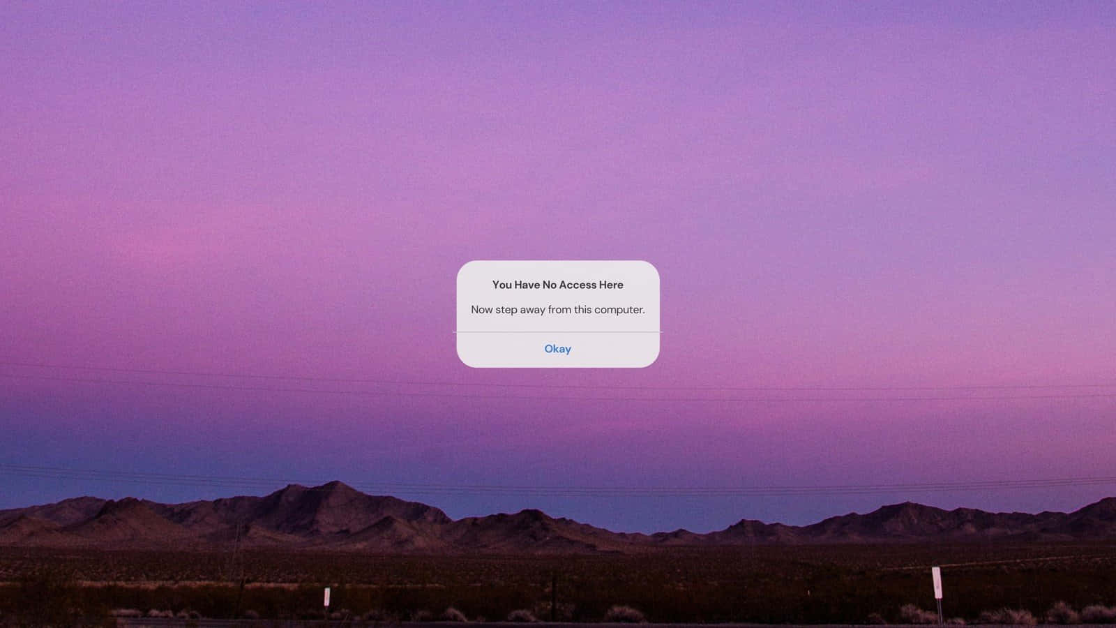 A Purple Sky With Mountains In The Background