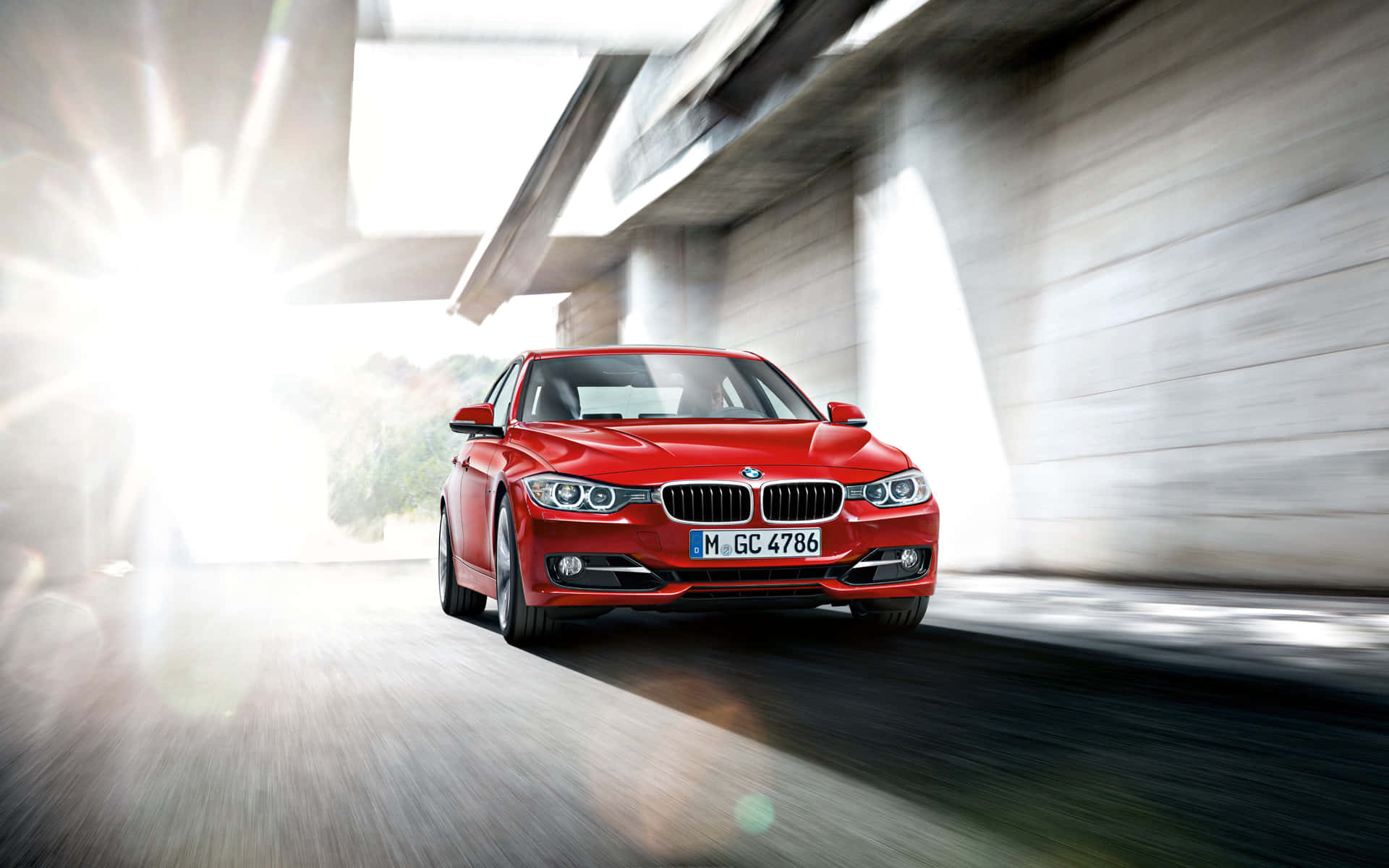 Bmw 3 Series - A Red Car Driving Down A Road