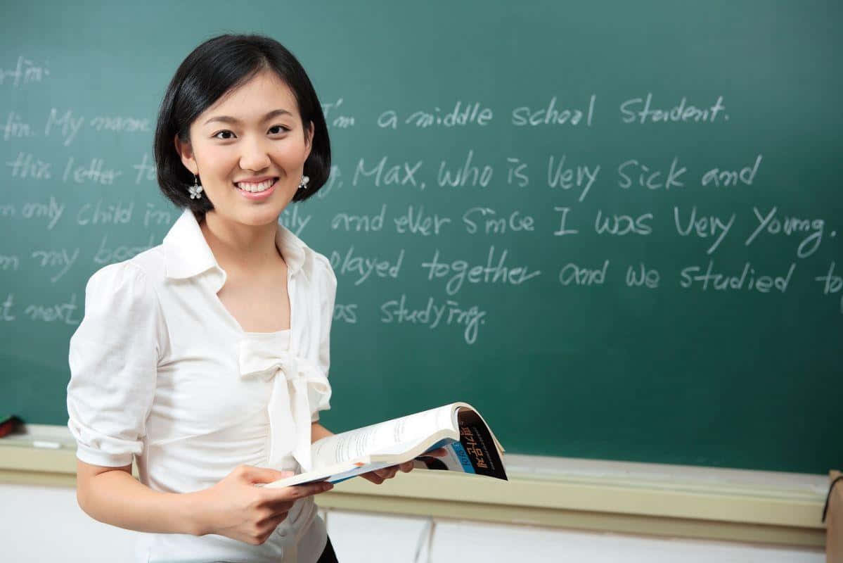 Cute Teacher On Blackboard