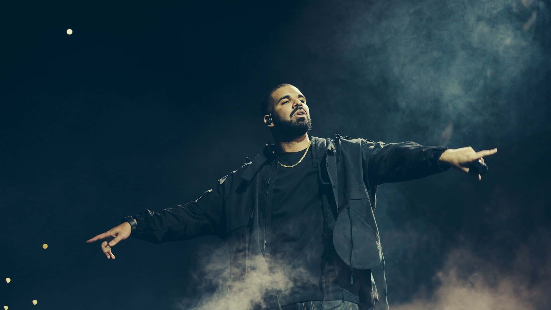 Drake Is Standing On Stage With His Arms Outstretched