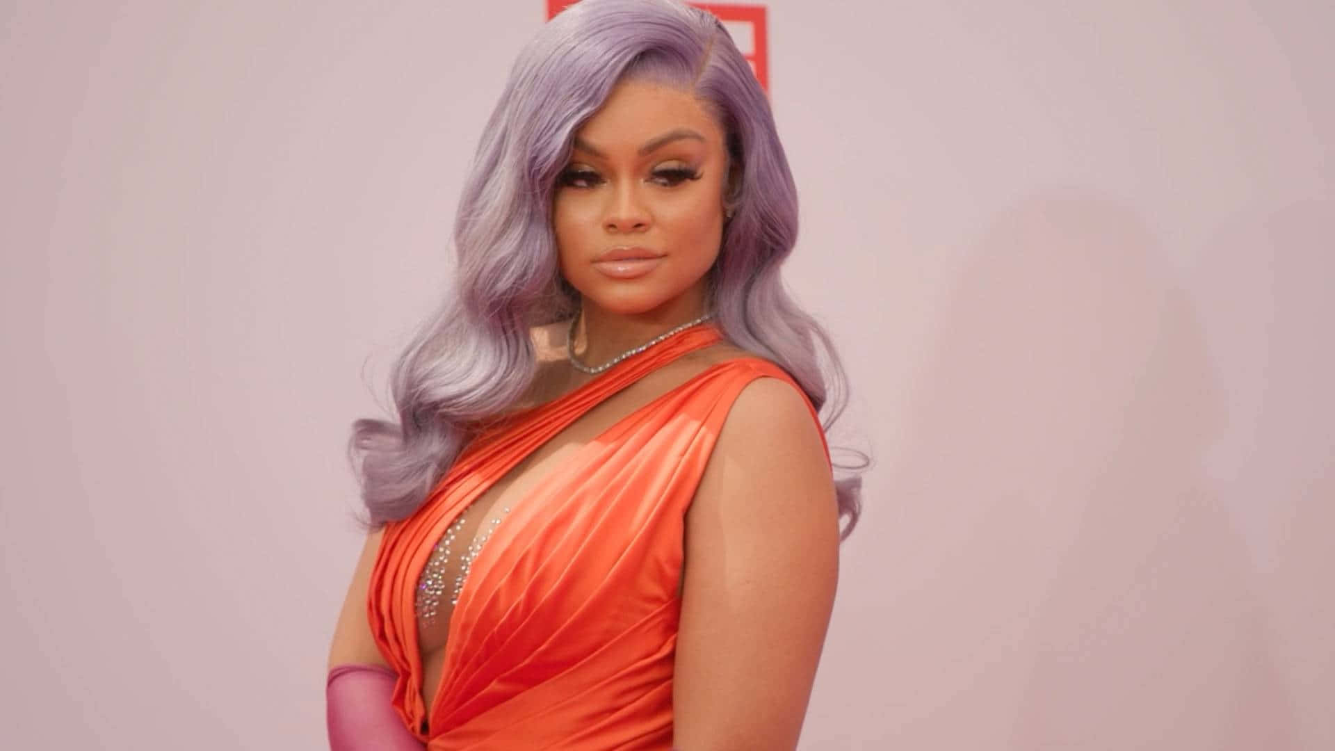 Elegant Celebrityin Orange Gown