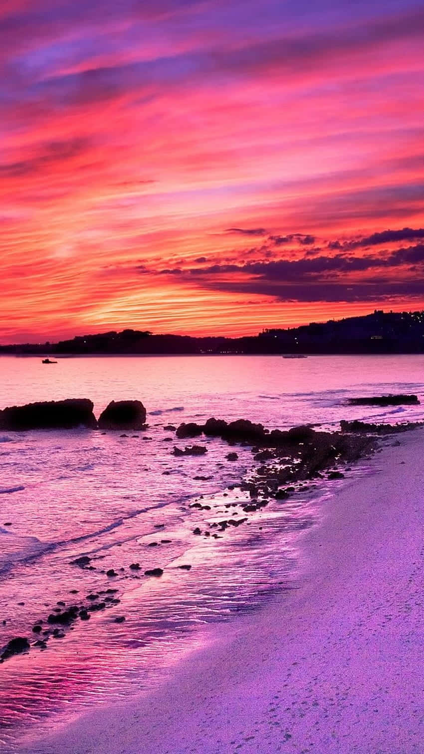Soak In The Dreamy Pink Sunset With The Waves Lapping At Your Feet.