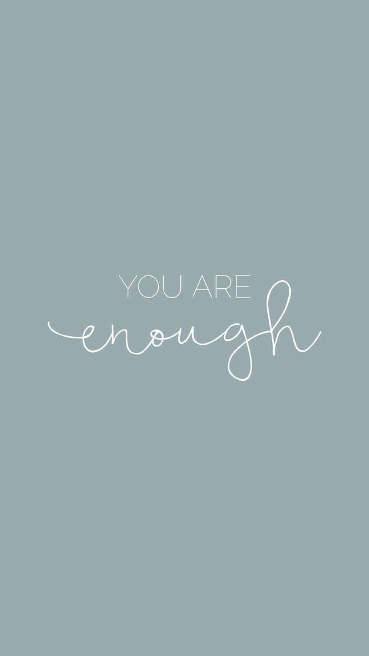 You Are Enough - A White Handwritten Quote On A Blue Background