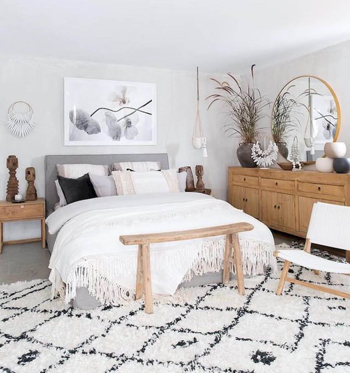 A Bedroom With A Bed, A Rug And A Mirror Wallpaper