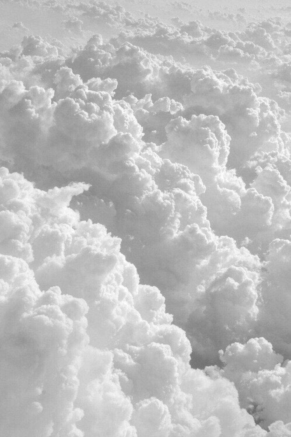 A Black And White Photo Of Clouds Above The Ground Wallpaper