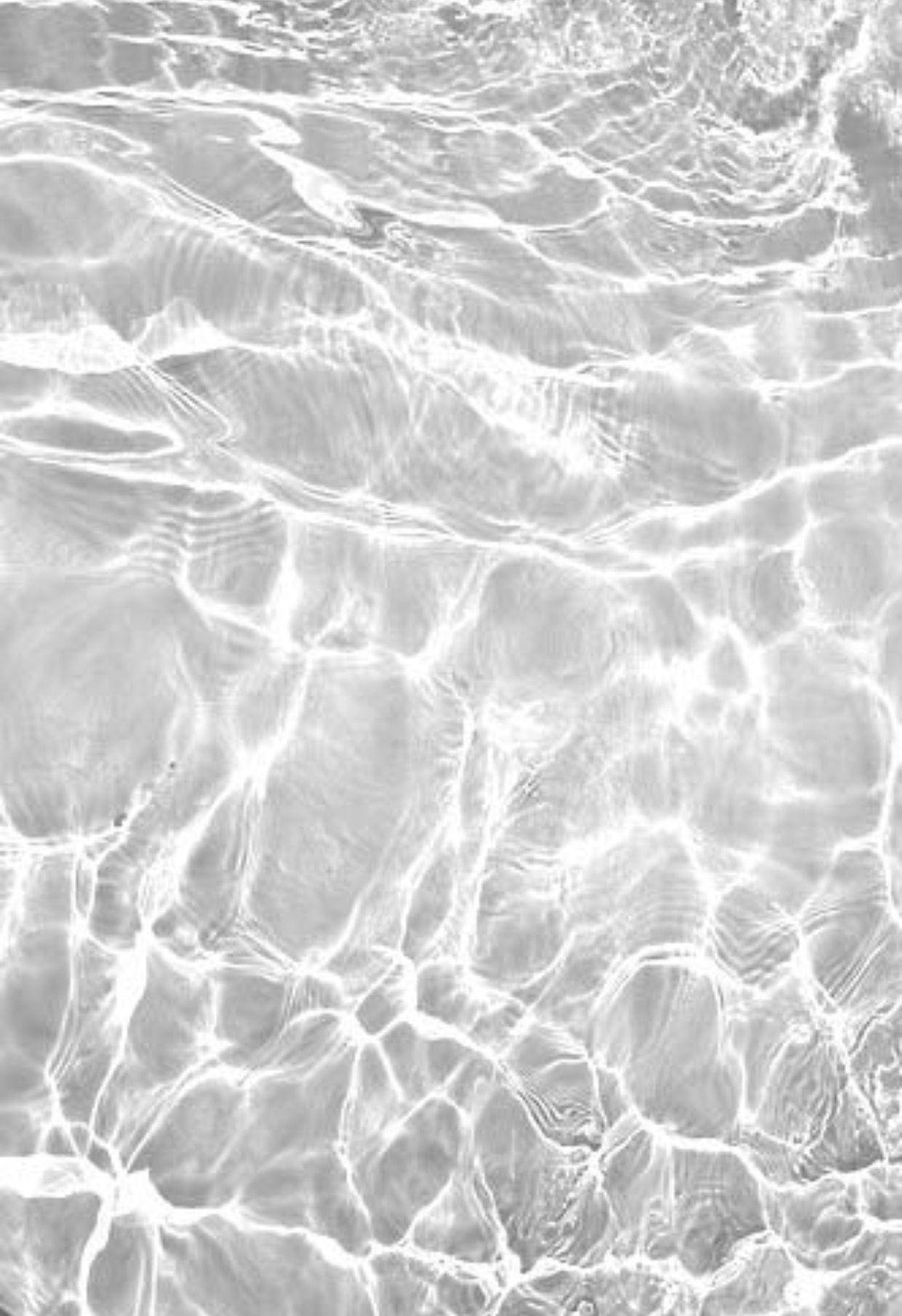 A Black And White Photo Of Water In The Ocean Wallpaper