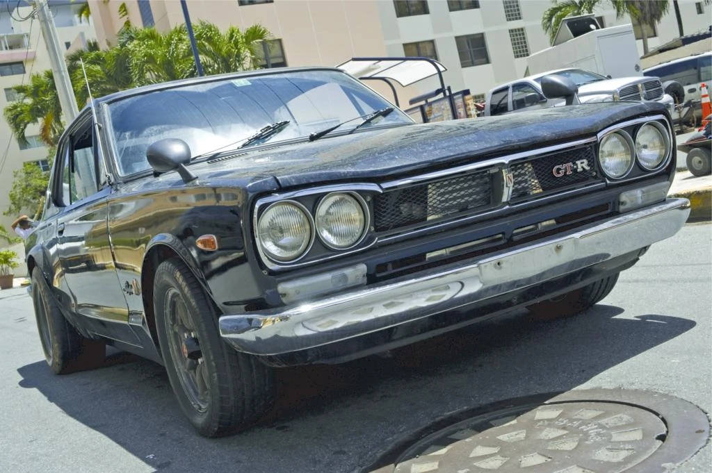 A Black Car Parked On A Street Wallpaper