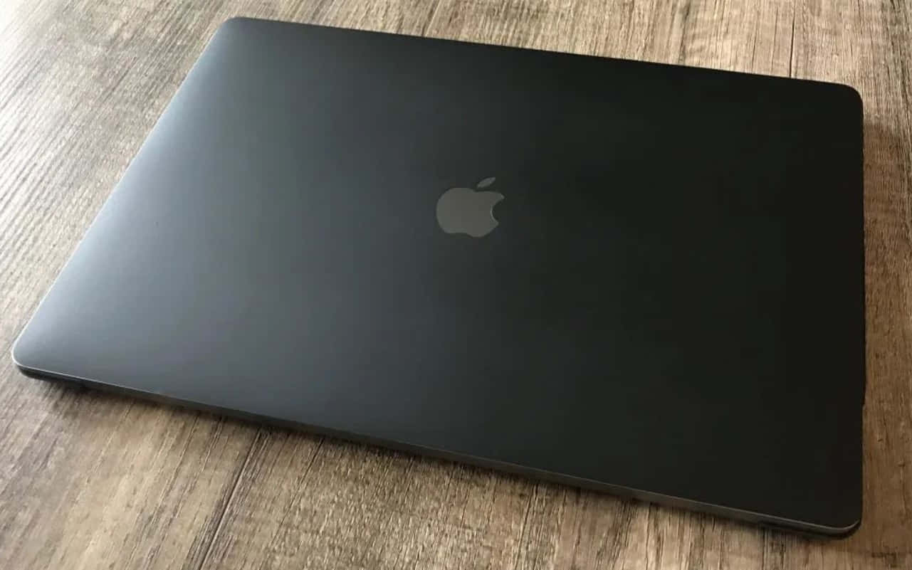 A Black Macbook With A Clean Design Wallpaper