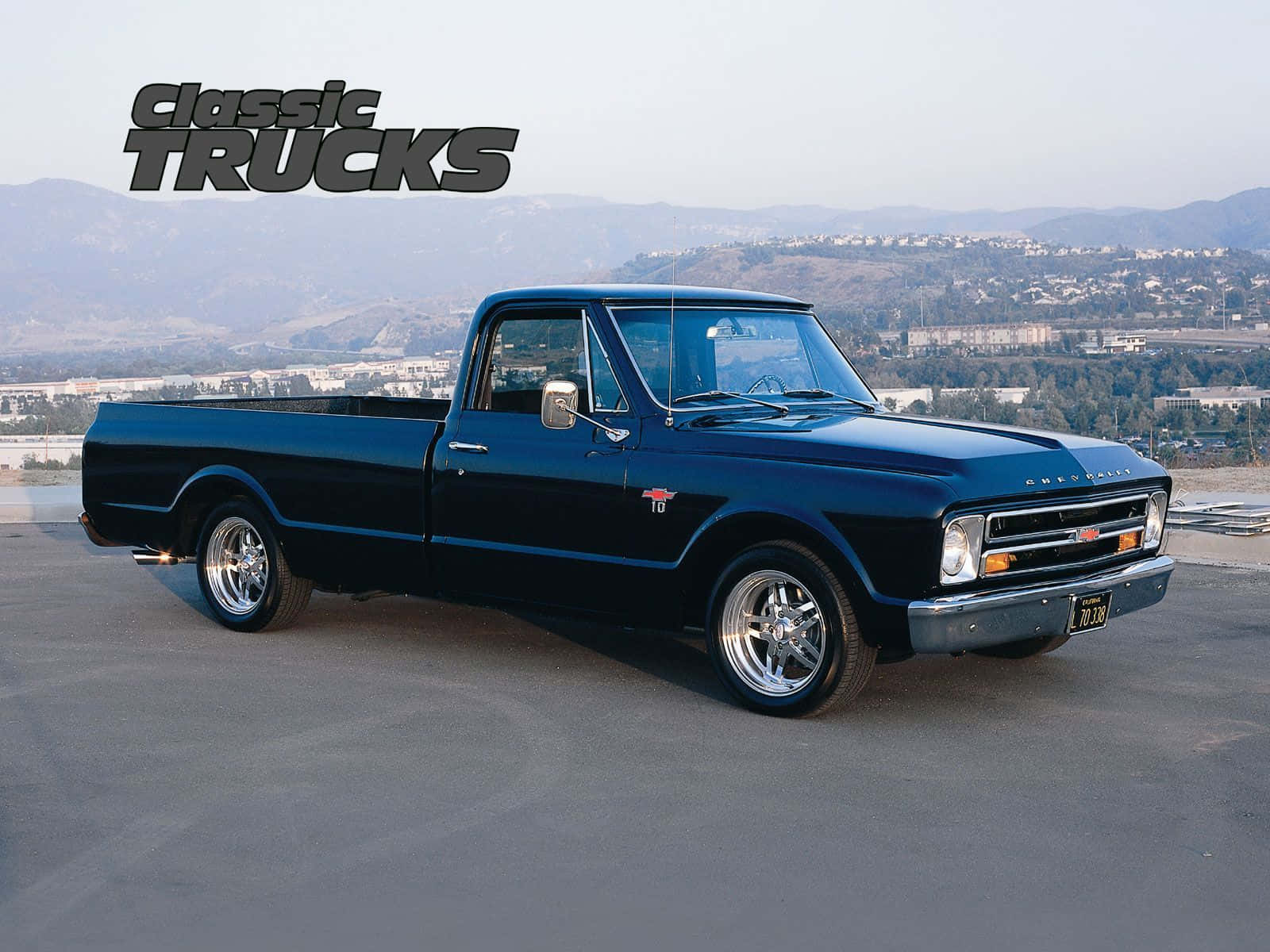 A Black Pickup Truck Parked In Front Of A Building Wallpaper