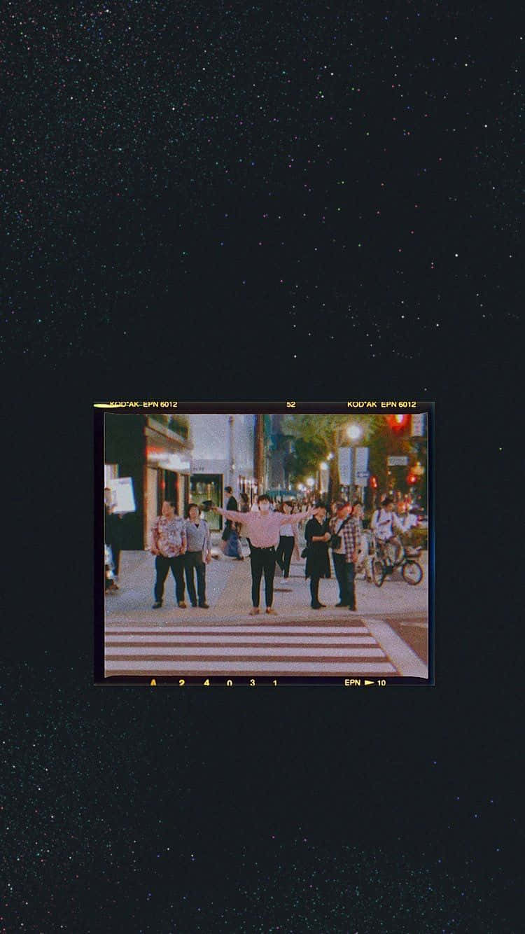 A Black Screen With A Picture Of People On A Street Wallpaper