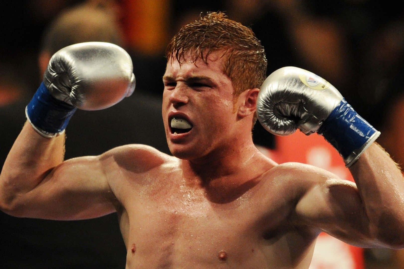 A Boxer Is Celebrating After Winning A Fight Wallpaper