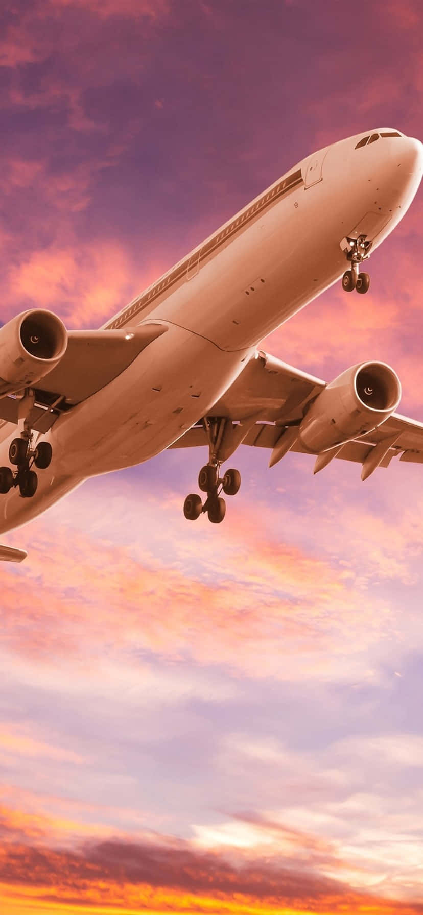 A Bright Pink Plane Soars Against A Blue Sky. Wallpaper