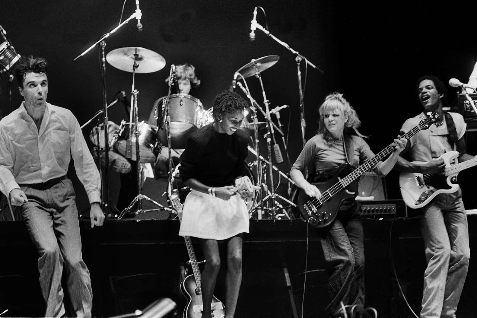 A Captivating Shot Of The Team Of Talking Heads In Their Element, On Stage. Wallpaper
