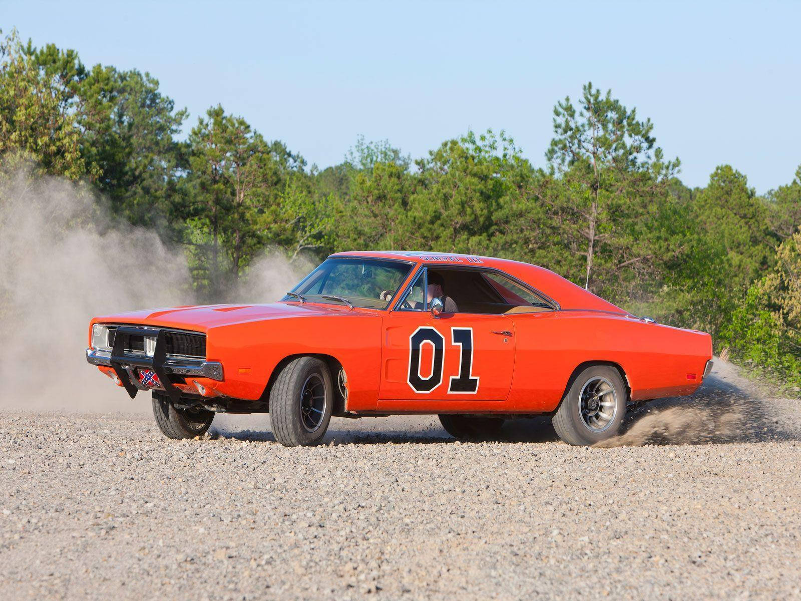 A Car Driving On Dirt Wallpaper