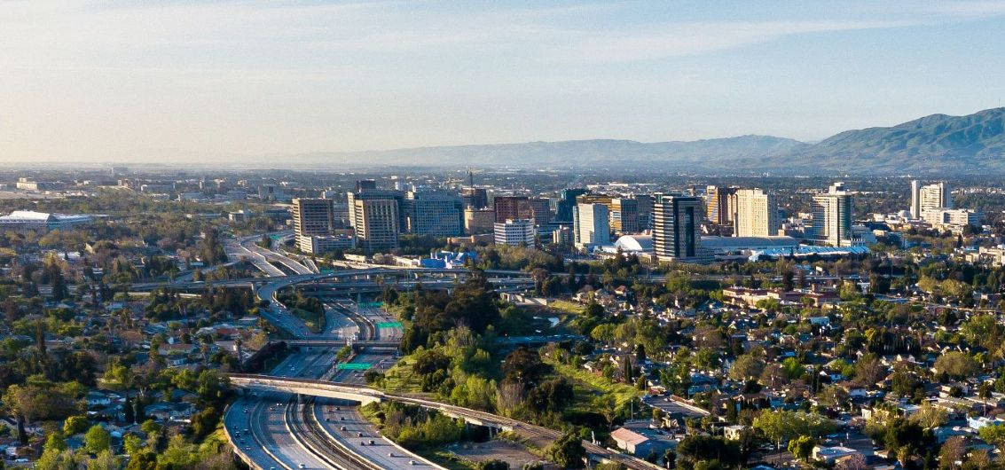 A City With A Highway And Trees In The Background Wallpaper