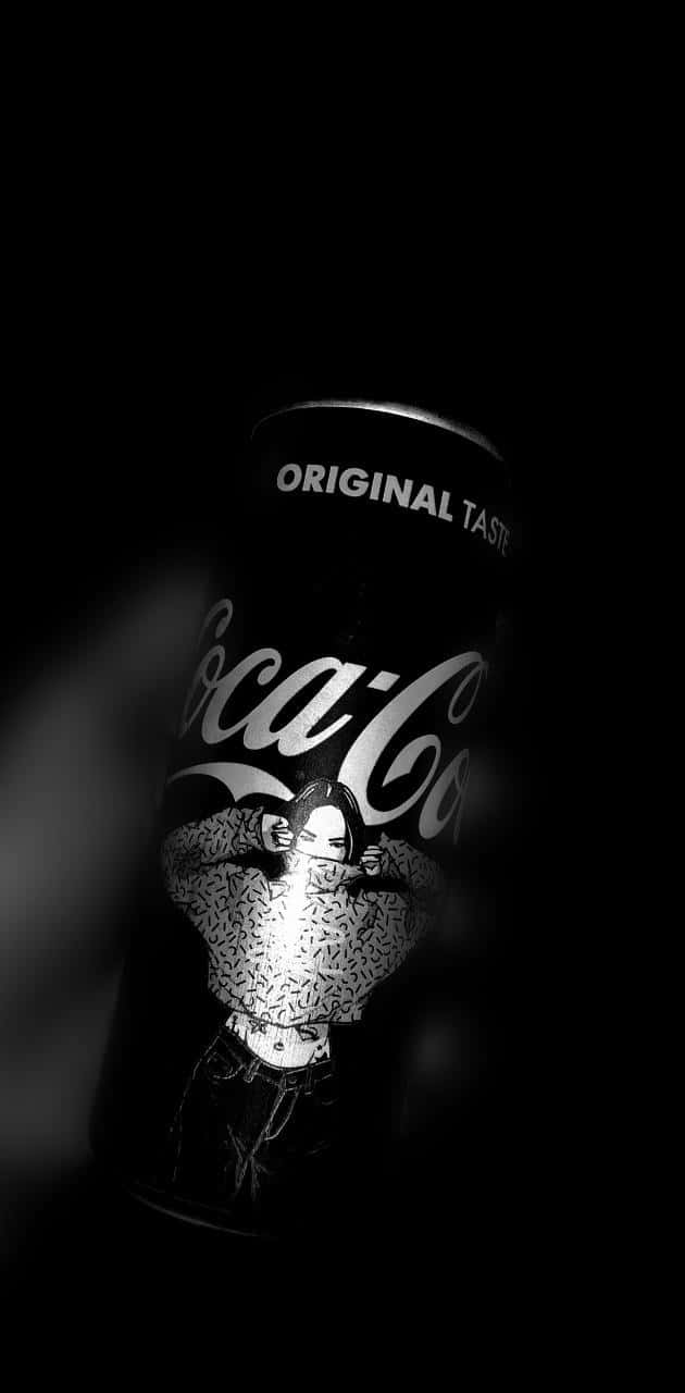 A Coca Cola Can Is Shown In The Dark Wallpaper