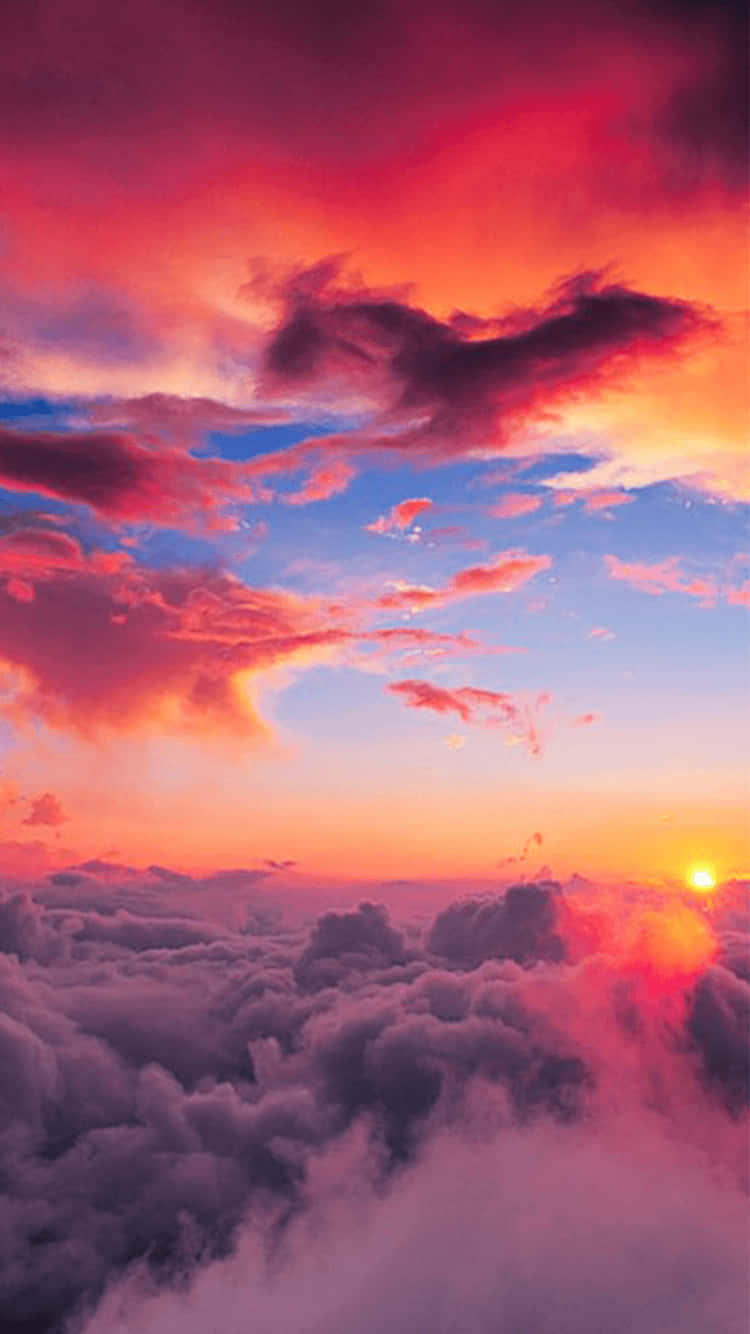 A Colorful Sunset Over The Clouds Wallpaper