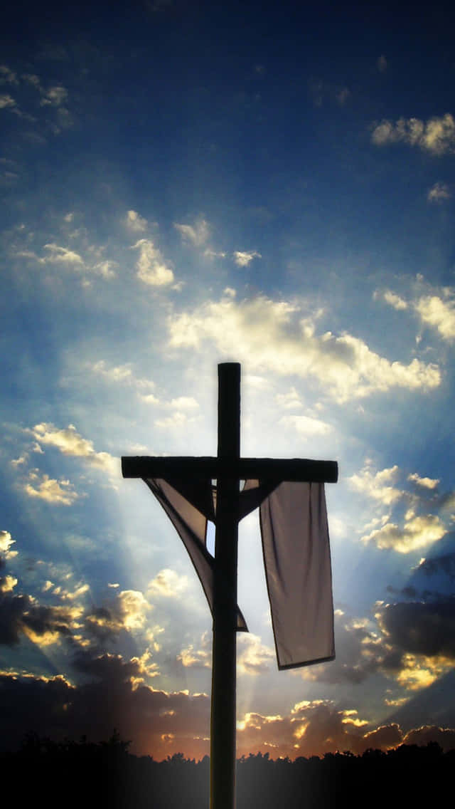 A Cross With A White Cloth Hanging From It Wallpaper