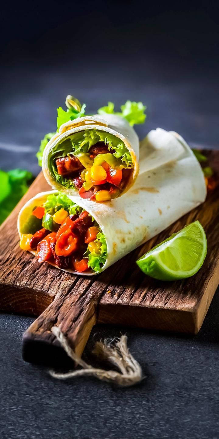 burrito with meat, vegetables and tomatoes on a dark background.  AI-Generated 32231581 Stock Photo at Vecteezy