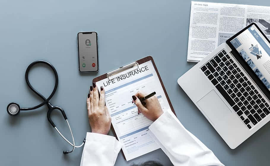 A Doctor Is Writing A Life Insurance Form On A Clipboard Wallpaper