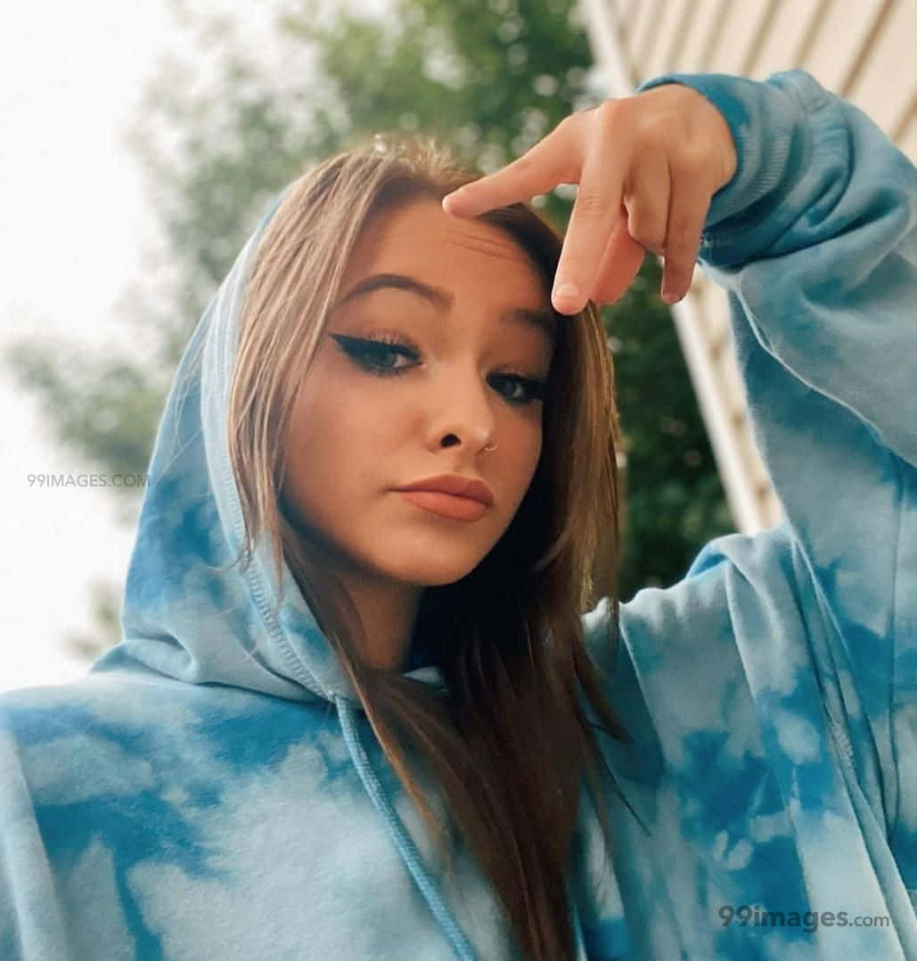 A Girl Wearing A Blue Tie Dye Hoodie Wallpaper