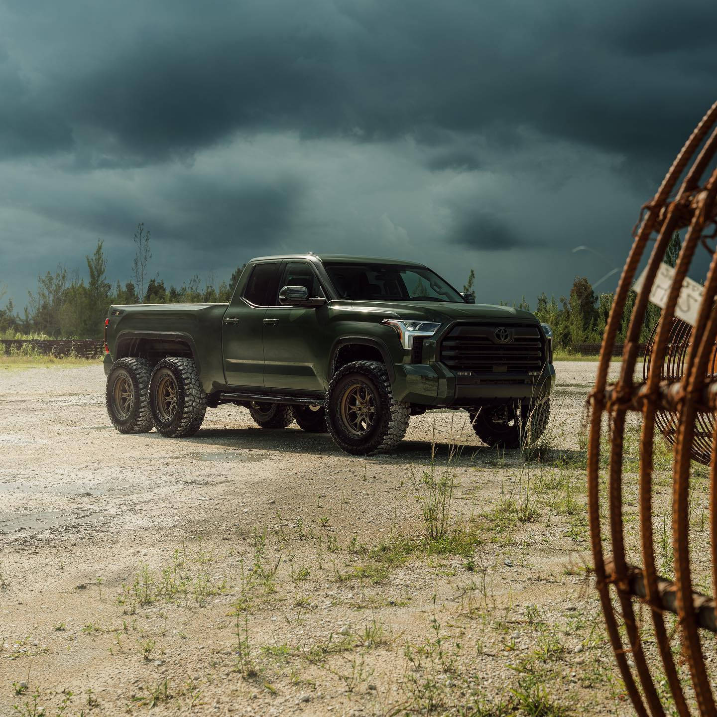 A Green Truck Is Parked In A Field With A Wire Fence Wallpaper