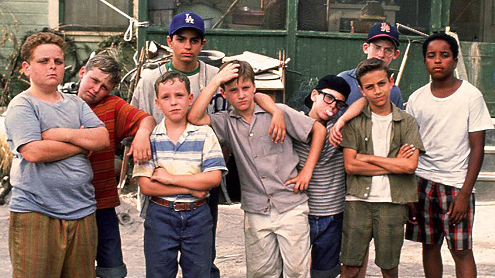 A Group Of Boys Standing In Front Of A Building Wallpaper