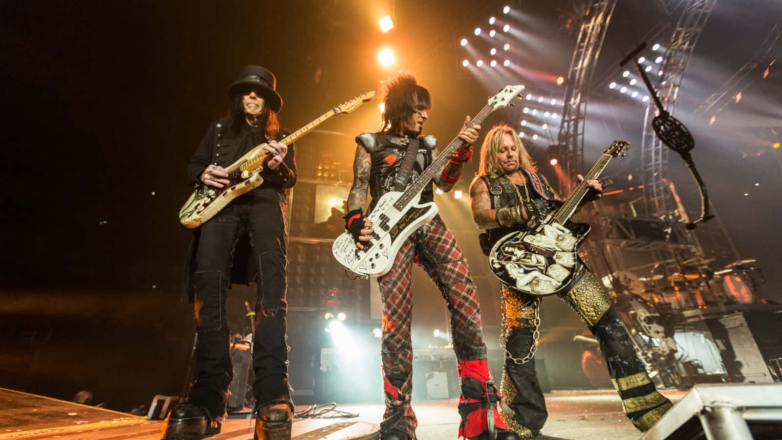 A Group Of People Standing On Stage With Guitars Wallpaper