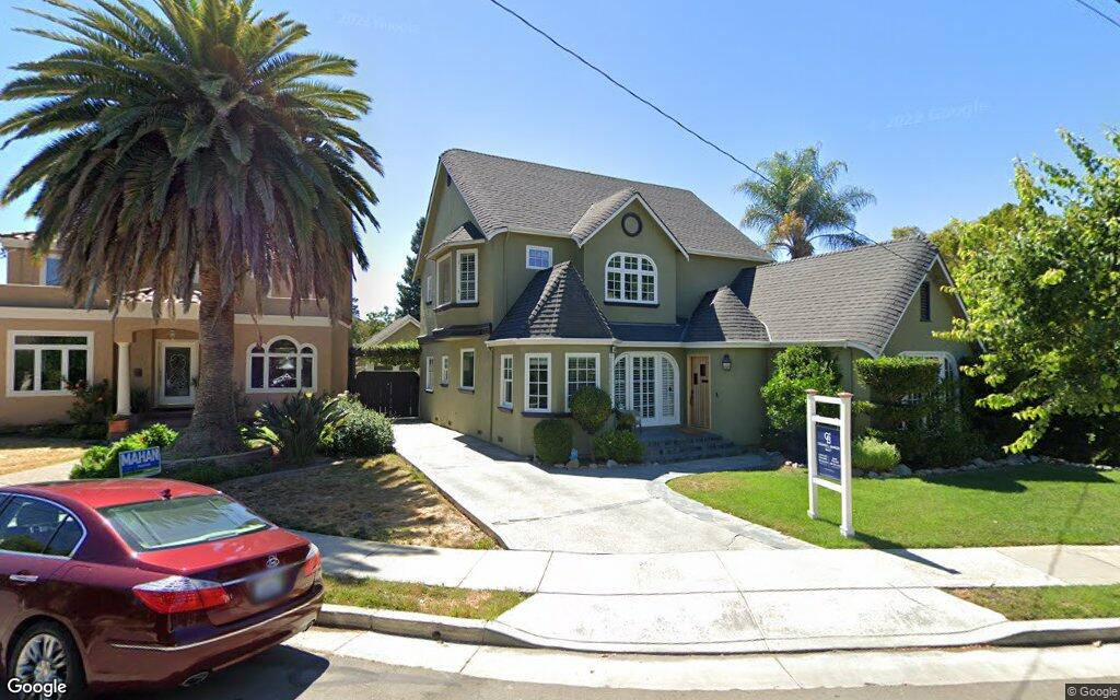 A House With A Car Parked In Front Of It Wallpaper