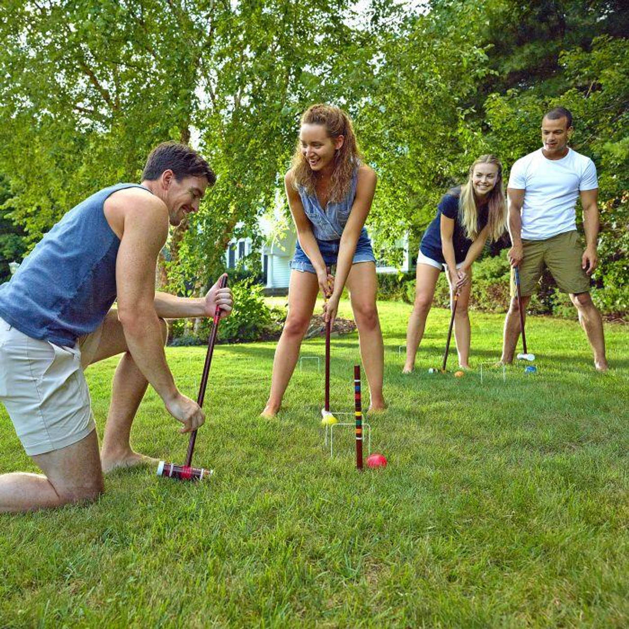 A Joyful Family Playing Croquet Outdoors Wallpaper