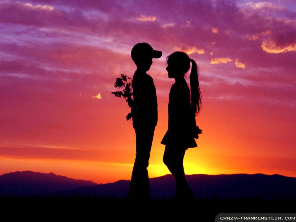 A Loving Couple Seize The Stunning Sunset Wallpaper
