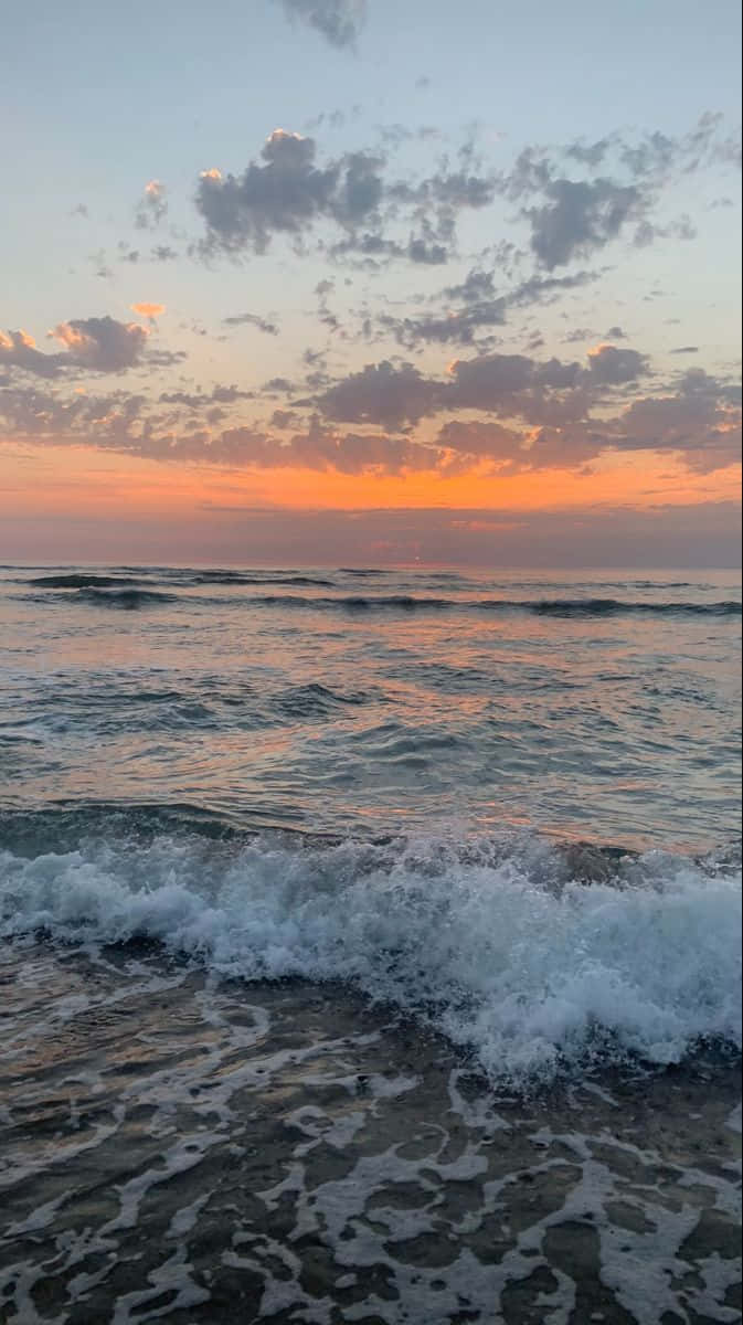 A Majestic View Of The Ocean At Sunrise. Wallpaper