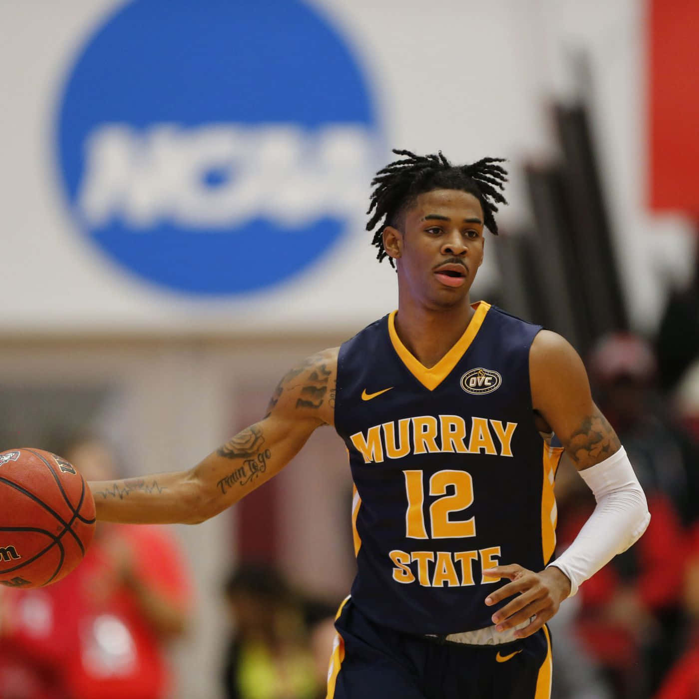 A Man In A Basketball Uniform Dribbling A Ball Wallpaper