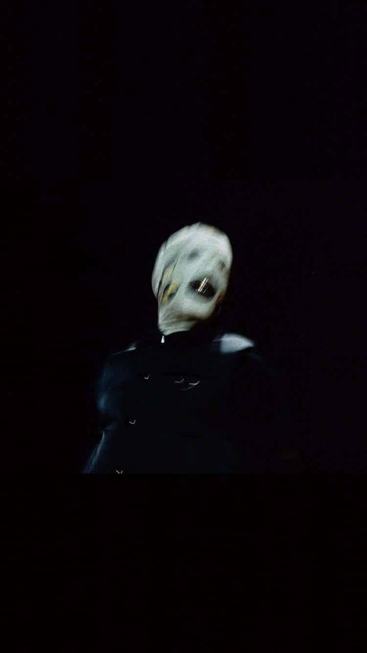 A Man In A Mask Is Standing In The Dark Wallpaper