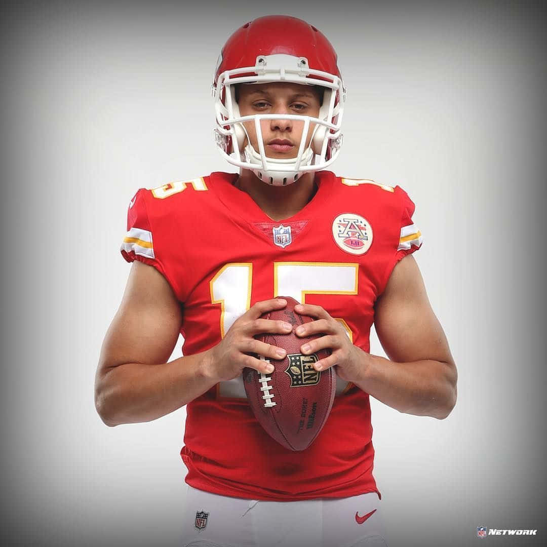 A Man In A Red Uniform Holding A Football Wallpaper