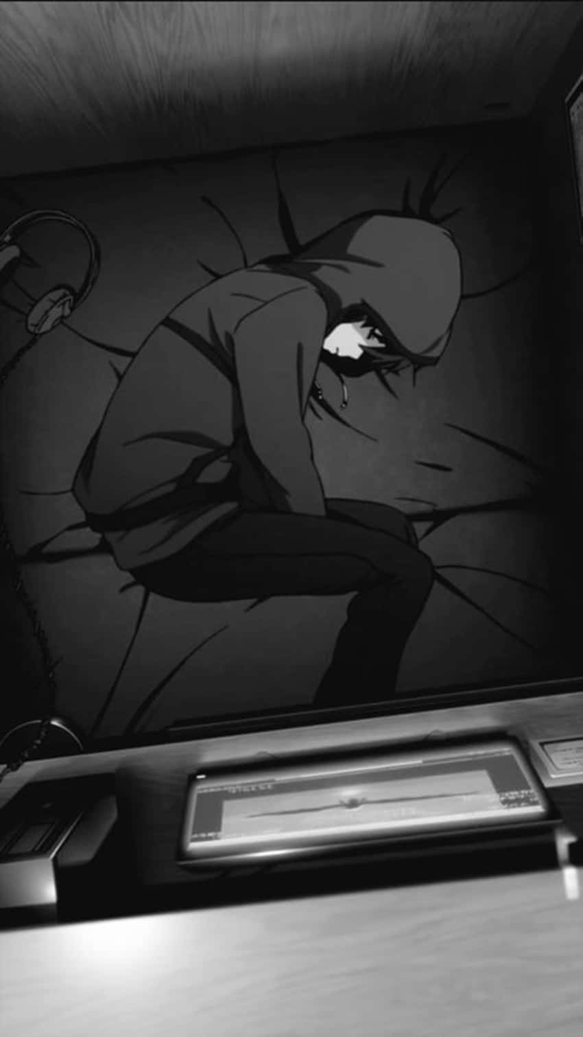 A Man Is Sitting In A Dark Room With A Hoodie Wallpaper